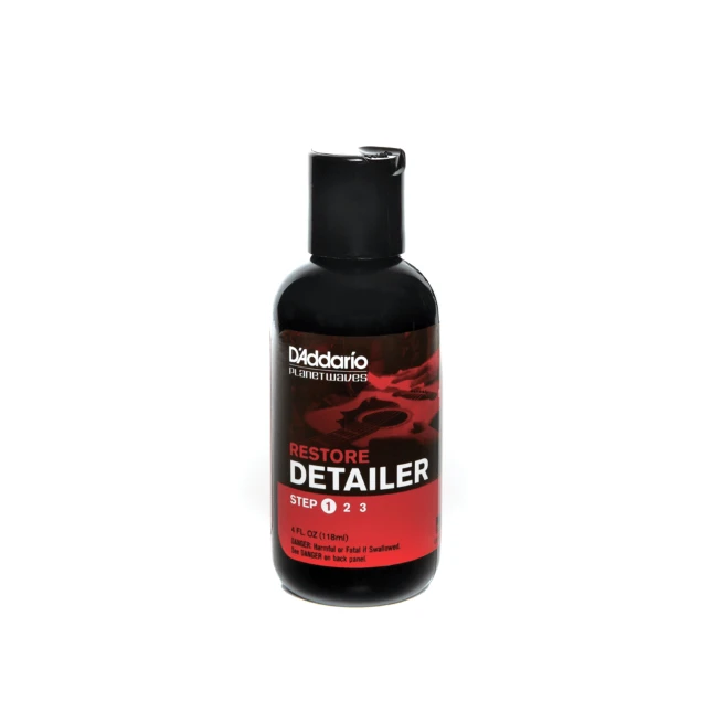D'Addario Restore Guitar Polish bottle with red label on a black container
