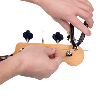 D'Addario Bass Pro-Winder, Black, a bass string winder in use on a wooden headstock