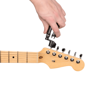 D'Addario Pro-Winder in black used on a guitar headstock to wind tuning pegs.