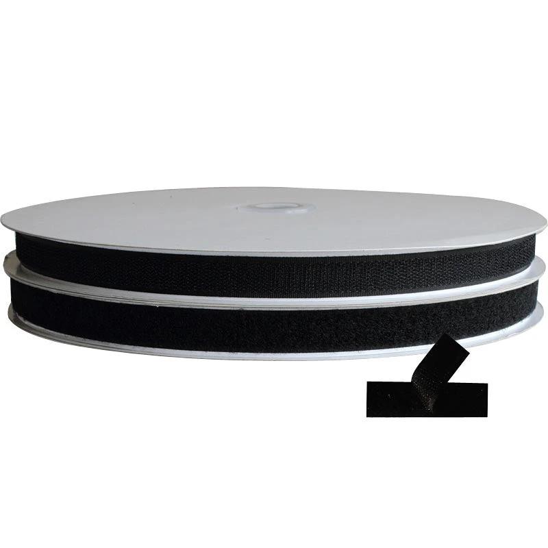 Roll of black hook and loop Velcro adhesive on a white background