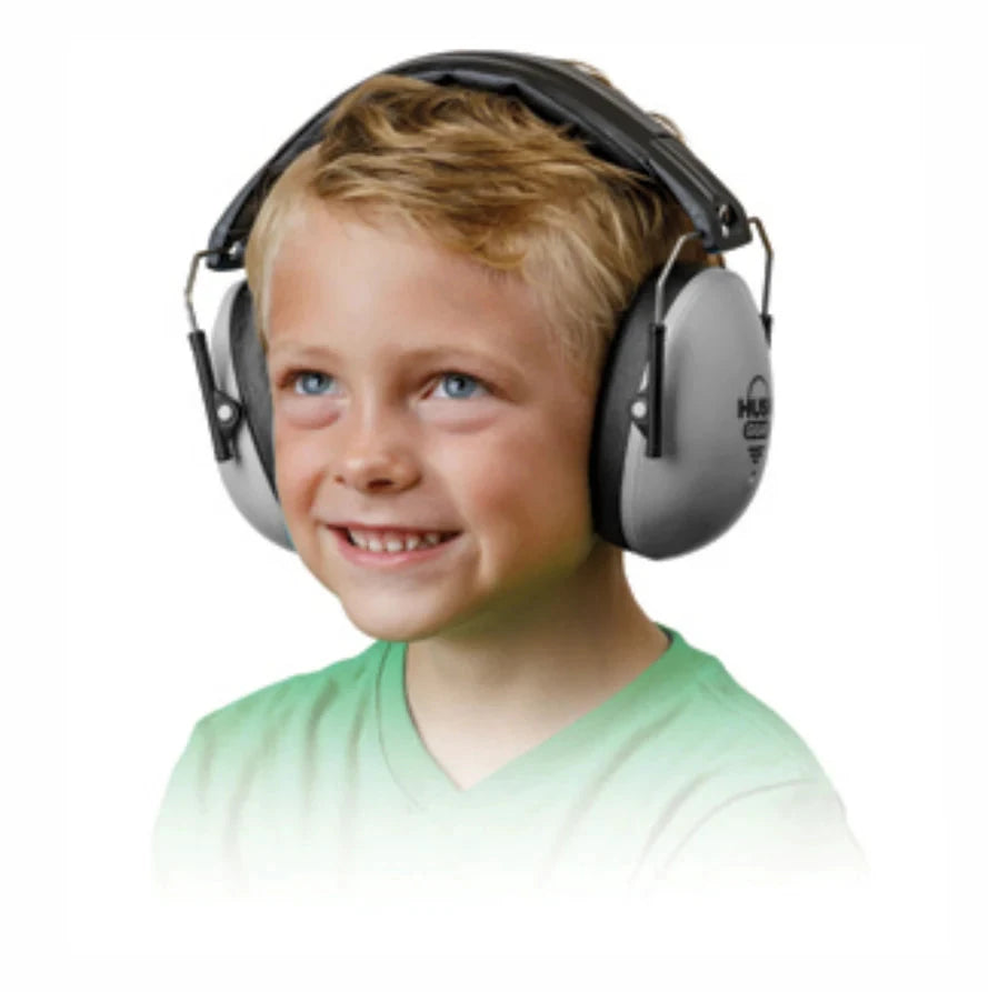 Child wearing a pair of Hush ear protection headphones on a white background