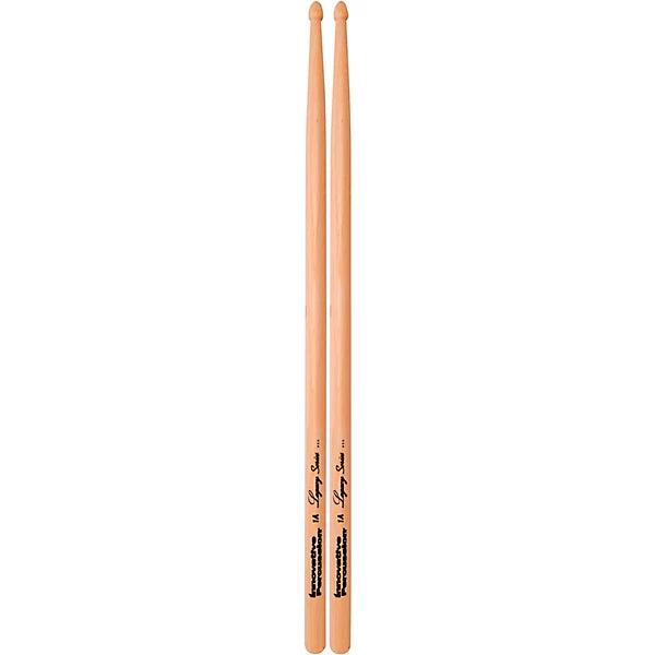 Two wooden drumsticks standing upright on a plain white background, with black printed branding and text near the lower section.
