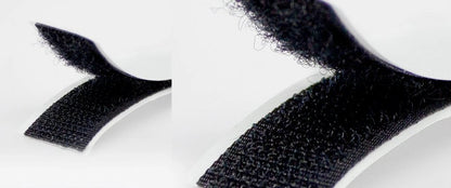 Close-up of black adhesive strips on a white background